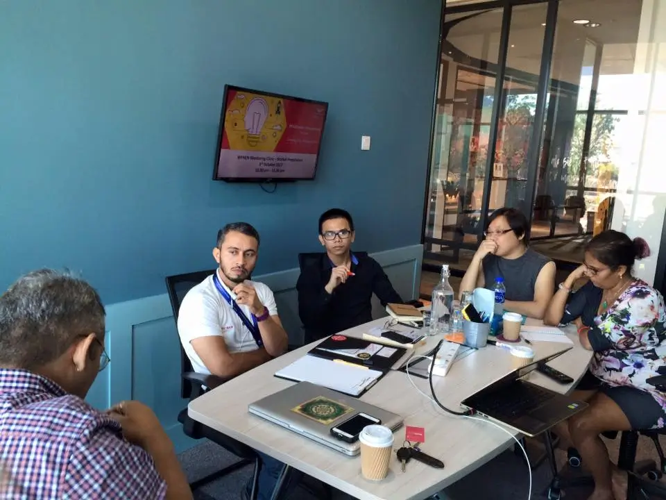 A facilitator explaining to an engaged small group