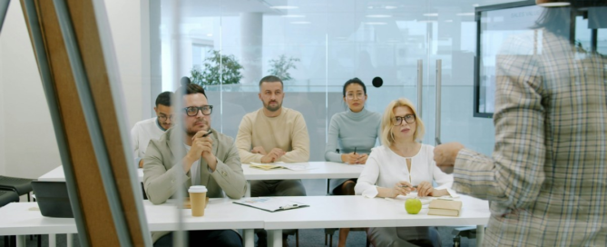 Meeting participants displaying a range of non-verbal communication signals during team discussion