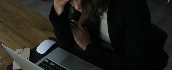 Team members showing signs of disengagement during an unproductive workplace meeting